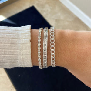 Female Model Wearing Diamond Ovals Bangle Bracelet - 18K gold weighing 11.62 grams - 14 oval-shaped diamonds weighing 4.83 carats