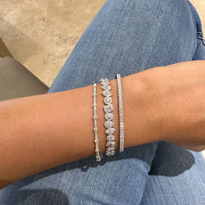 Female Model Wearing Mixed Shape Halo Diamond Bangle Bracelet - 14K gold weighing 13.30 gram - 15 mixed shape diamonds weighing 1.63 carats - 192 round diamonds weighing 0.88 carats