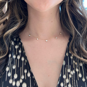 Female Model Wearing Bezel-Set Diamond Drip Necklace - 14K gold weighing 3.59 grams - 5 round diamonds weighing 0.89 carats