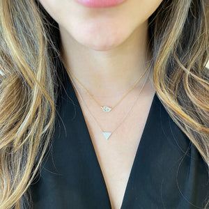 Female Model Wearing Baguette Diamond Leaf Pendant Necklace - 14K gold weighing 2.39 grams - 32 round diamonds weighing 0.09 carats - 11 baguette diamonds weighing 0.14 carats