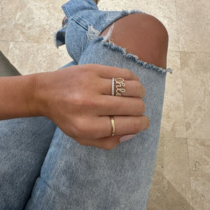 Female model wearing Diamond eternity band - 18K gold weighing 1.52 grams - 30 round diamonds totaling 0.84 carats