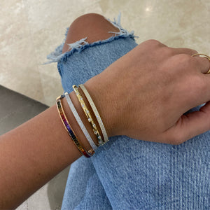 Female Model Wearing Fancy Sapphire Bangle - 18K gold weighing 15.09 grams - 35 fancy sapphires totaling 3.51 carats