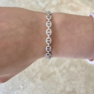 Female model wearing Diamond Tri-Link Bangle Bracelet -18K gold weighing 13.08 grams -140 round diamonds weighing .85 carats