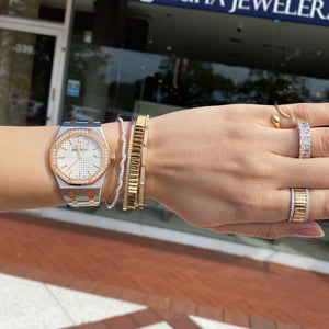 Female model wearing Solid 18k white gold weighing 9.14 grams with 65 round diamonds weighing 0.67 carats Diamond Twist Bangle | Nuha Jewelers