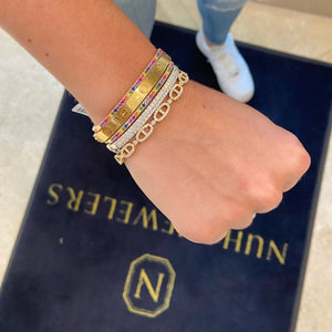 Female model wearing Multicolor Gemstone Bangle Bracelet - 14K gold weighing 9.99 grams - 35 multicolor gemstones totaling 1.02 carats