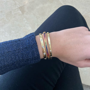 Female Model Wearing Bezel Set Oval, Pear, Heart, Marquee & Emerald-Cut Diamonds Bangle BraceletMixed Shape Diamonds Bangle -14K gold weighing 17.03 grams -5 mixed-shape diamonds weighing 0.68 carats (Pear - heart - emerald - oval - marquee)