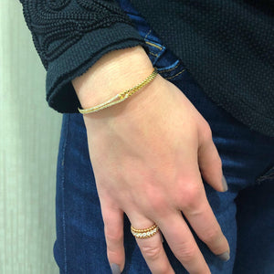 Female Model Wearing Diamond & Beaded Gold Eternity Ring 18k gold, 6.25 grams, 22 round brilliant-cut diamonds shared prong-set 1.78 carats.