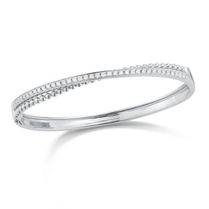 Diamond Two-Tone Crossover Bangle Bracelet -14K gold weighing 15.82 grams -39 round channel-set diamonds totaling .80 carats