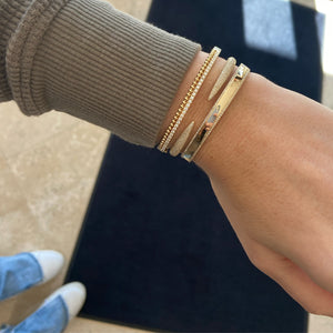 Female Model Wearing Diamond & Beaded Gold Bangle Bracelet -18K gold weighing 20.57 grams -39 round diamonds totaling 0.79 carats