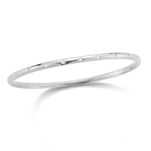 Diamond simple bangle bracelet -14K gold weighing 10.13 grams -9 round diamonds totaling 0.26 carats. - 3mm wide.