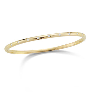 Diamond simple bangle bracelet -14K gold weighing 10.13 grams -9 round diamonds totaling 0.26 carats. - 3mm wide.