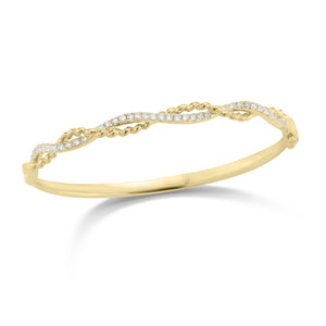 Diamond Twist Bangle Bracelet -18K gold weighing 18.57 grams -39 round shared prong-set diamonds totaling 0.70 carats.