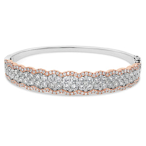 Diamond Two-Tone Bangle Bracelet -18K rose gold weighing 20.63 grams -52 round diamonds totaling 2.90 carats -157 pave diamonds totaling 1.33 carats