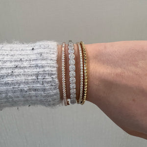 Female Model Wearing Solid 14K yellow gold weighing 16.06 grams featuring 35 round diamonds weighing 0.97 carats Diamond & Gold Pyramid Bangle | Nuha Jewelers