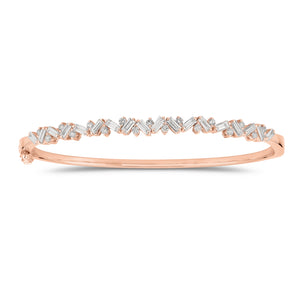Slim Baguette and Round Diamond Bangle - 14K gold weighing 11.76 grams - 18 slim baguettes weighing 1.04 carats - 17 round diamonds weighing 0.37 carats