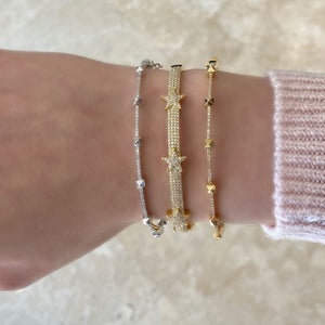 Female Model Wearing Diamond Tri-Star Bangle Bracelet -14K gold weighing 13.48 grams -301 round diamonds totaling 0.75 carats