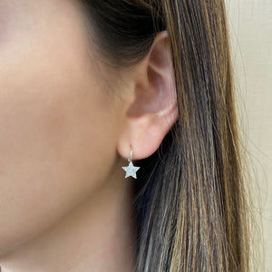 Female Model Wearing Diamond Star Lever-Back Earrings  -14K gold weighing 1.31 grams  -68 round pave set diamonds totaling 0.18 carats