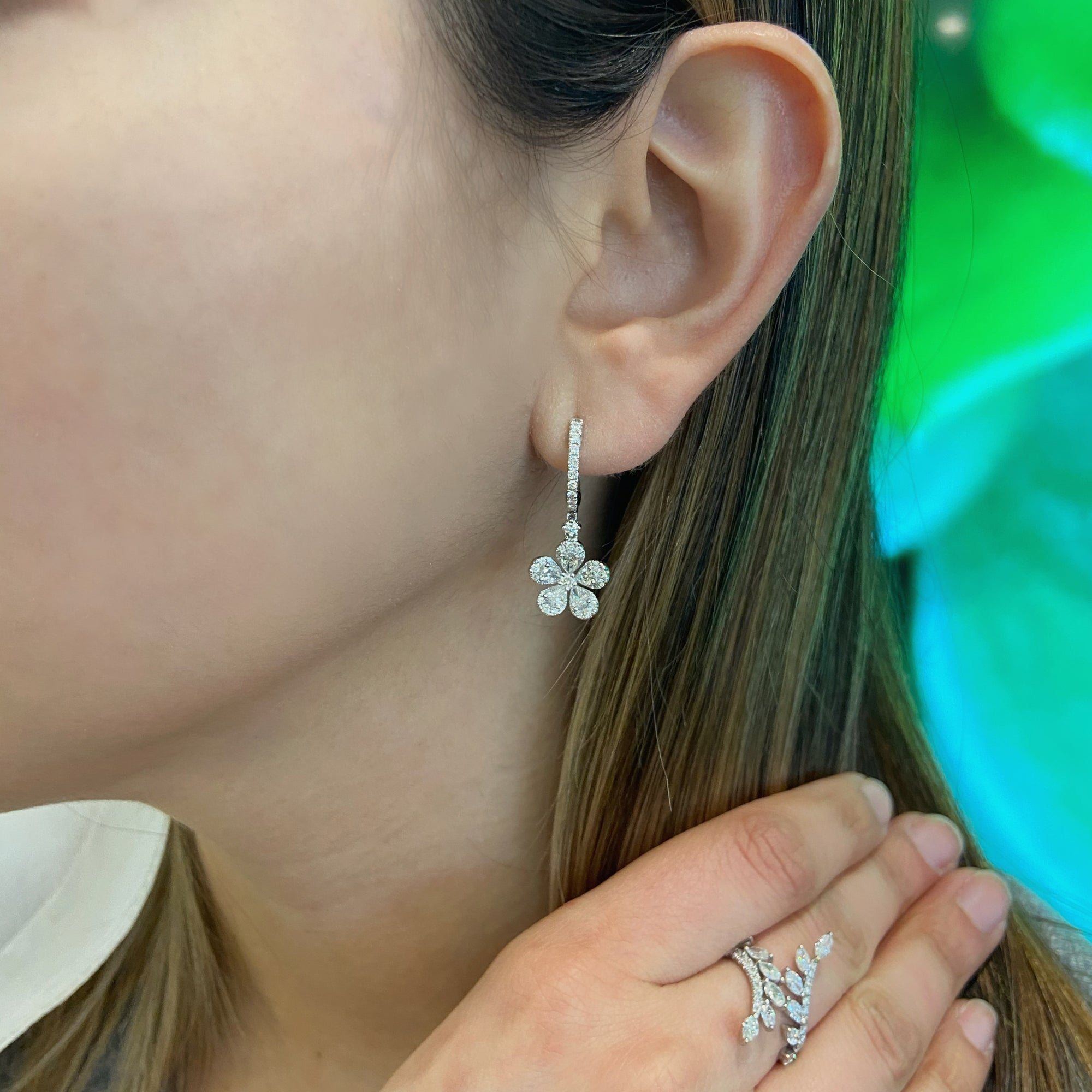 Diamond Flower Huggie Earrings  18k gold, 4.01 grams, 72 round diamonds .57 carats, 10 pear shape prong set diamonds 1.01 carats.