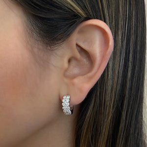 Female Model Wearing Diamond Wide Huggie Earrings - 14K gold weighing 4.94 grams  - 34 round diamonds totaling 1.80 carats