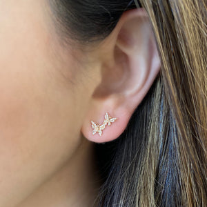Female model wearing Diamond Butterfly Crawler Earrings - 14k gold weighing 1.50 grams - 70 round diamonds weighing .16 carats. 