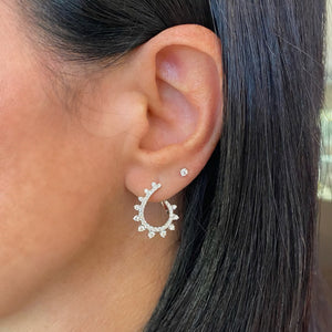 Female Model Wearing Diamond Intricate Swirl Front-Facing Earrings - 18K gold weighing 4.03 grams  - 72 round diamonds weighing 0.94 carats