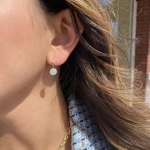 Female Model wearing Solid 14K white gold weighing 1.55 grams featuring 76 round diamonds weighing 0.22 carats Pave Diamond Disc Lever-Back Earrings | Nuha Jewelers