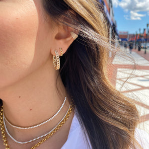 Female Model Wearing Gold Cuban Chain Huggie Earrings  - 14K gold weighing 2.03 grams