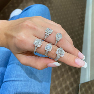 Female Model Wearing Three-Stone Emerald-Cut Diamond Engagement Ring  -18K weighting 3.98 GR  - 42 round diamonds totaling 0.62 carats