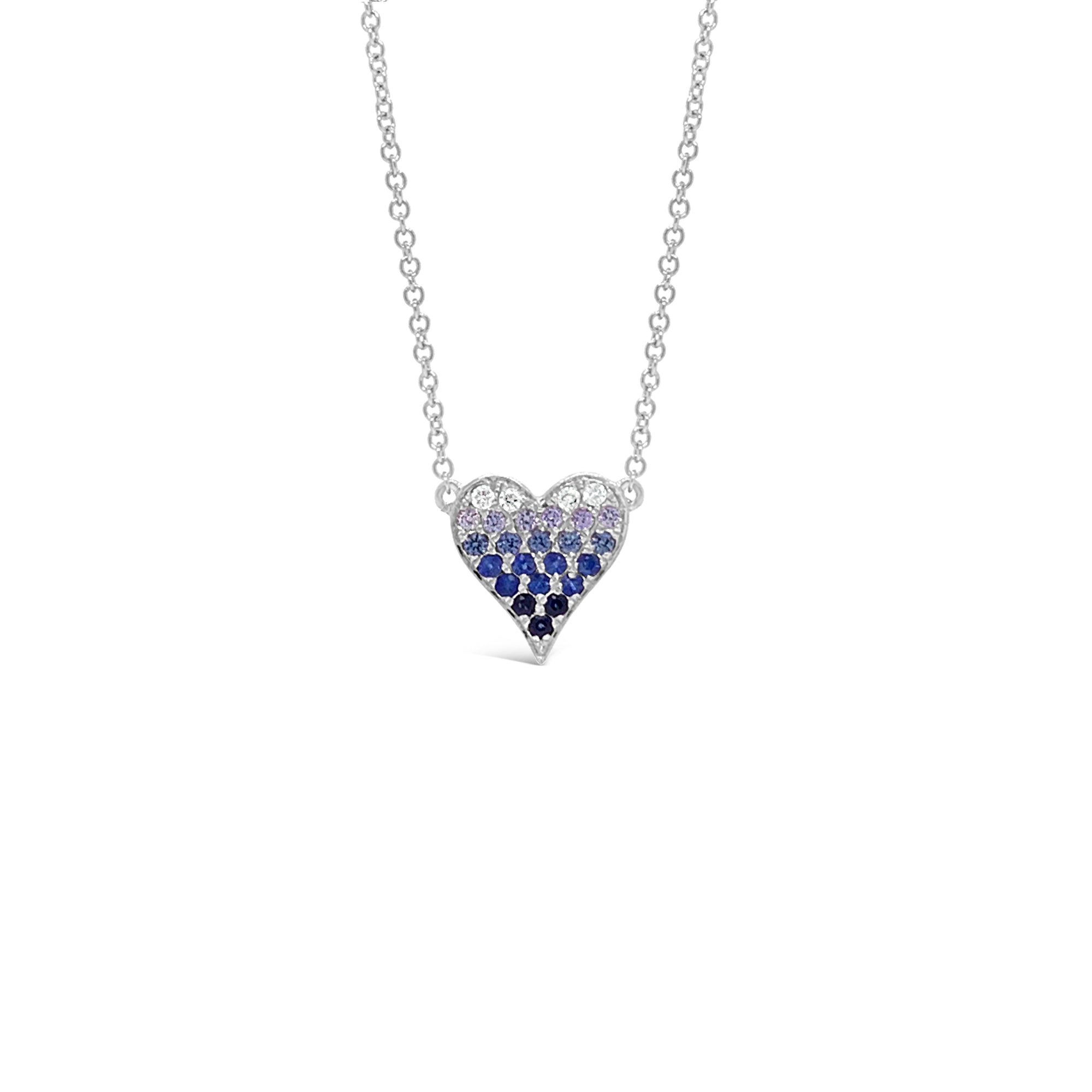Female Model Wearing Sapphire Gradient Mini Pink Diamond Heart Pendant Necklace  -14K gold weighing 1.98 grams  -4 round diamonds totaling 0.05 carats  -21 sapphires totaling 0.24 carats