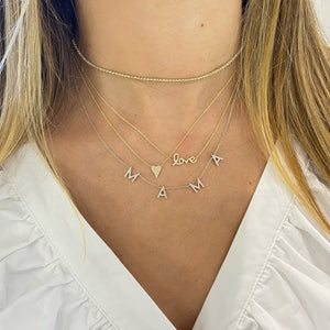 Female Model wearing Small Diamond Mama Necklace  - 14K gold weighing 2.66 grams  - 74 round diamonds totaling 0.25 carats
