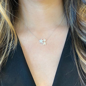 Female Model Wearing Diamond Star Trio Necklace  - 14K gold weighting 2.60 grams.  - 109 round diamond totaling 0.38 carats.