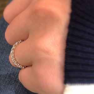 Female model wearing Classic Shared Prong-Set Diamond Eternity Band -18k gold weighing 3.07 grams -21 round diamonds weighing 2.05 carats