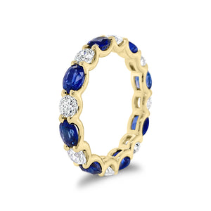 Sapphire & Diamond Eternity Ring - 18K gold weighing 2.67 grams - 8 round diamonds totaling 1.10 carats - 8 oval-shaped sapphires totaling 2.46 carats