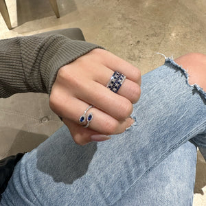 Female model wearing Sapphire and Diamond Eternity Ring - 18K gold weighing 1.52 grams - 14 sapphires weighing 0.70 carats - 14 round diamonds weighing 0.47 carats