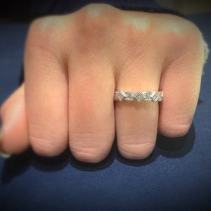 Female model wearing Geometric diamond eternity band ring -14k gold weighing 4.1 grams -8 round diamonds weighing .24 carats -9 PR weighing .68 carats