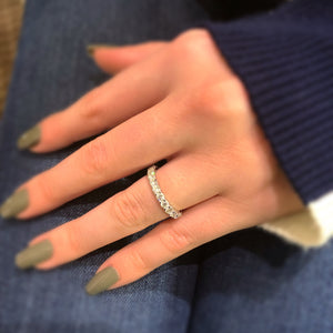 Female Model Wearing Slim Shared Prong-Set Diamond Eternity Band -14k gold weighing 2.3 grams -25 round shared prong-set diamonds weighing 1.43 carats