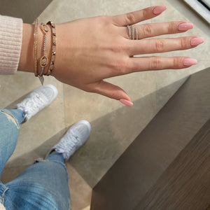 Female model wearing Skinny Pave Diamond Pyramid Stud Bangle Bracelet - 14K gold weighing 13.86 grams - 252 round diamonds totaling 0.95 carats