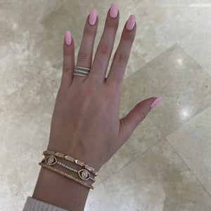 Female model wearing Skinny Pave Diamond Pyramid Stud Bangle Bracelet - 14K gold weighing 13.86 grams - 252 round diamonds totaling 0.95 carats