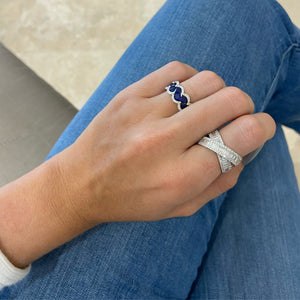 Female Model Wearing Sapphire and Diamond Scalloped Ring - 18K gold weighing 5.59 grams  - 60 round diamonds weighing 0.30 carats  - 9 pear-shaped sapphires weighing 2.39 carats