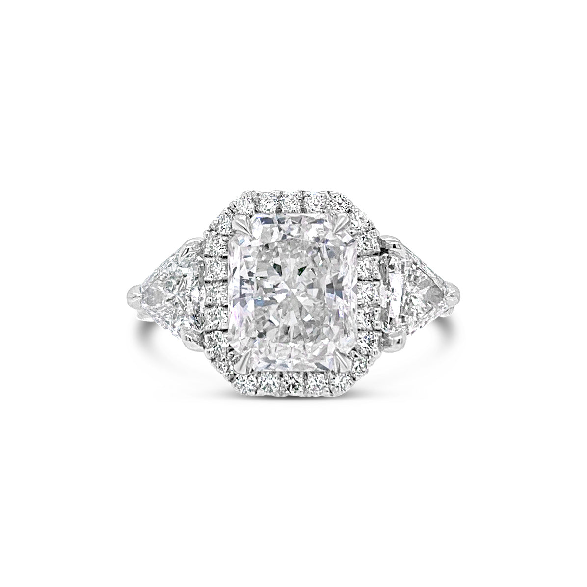 Three-Stone Elongated Radiant-Cut Diamond Engagement Ring  - 18KT white gold weighing 4.2 grams.  - 34 Round diamonds totaling .43 carats