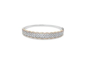 Diamond Two-Tone Bangle Bracelet -18K yellow gold weighing 20.63 grams -52 round diamonds totaling 2.90 carats -157 pave diamonds totaling 1.33 carats