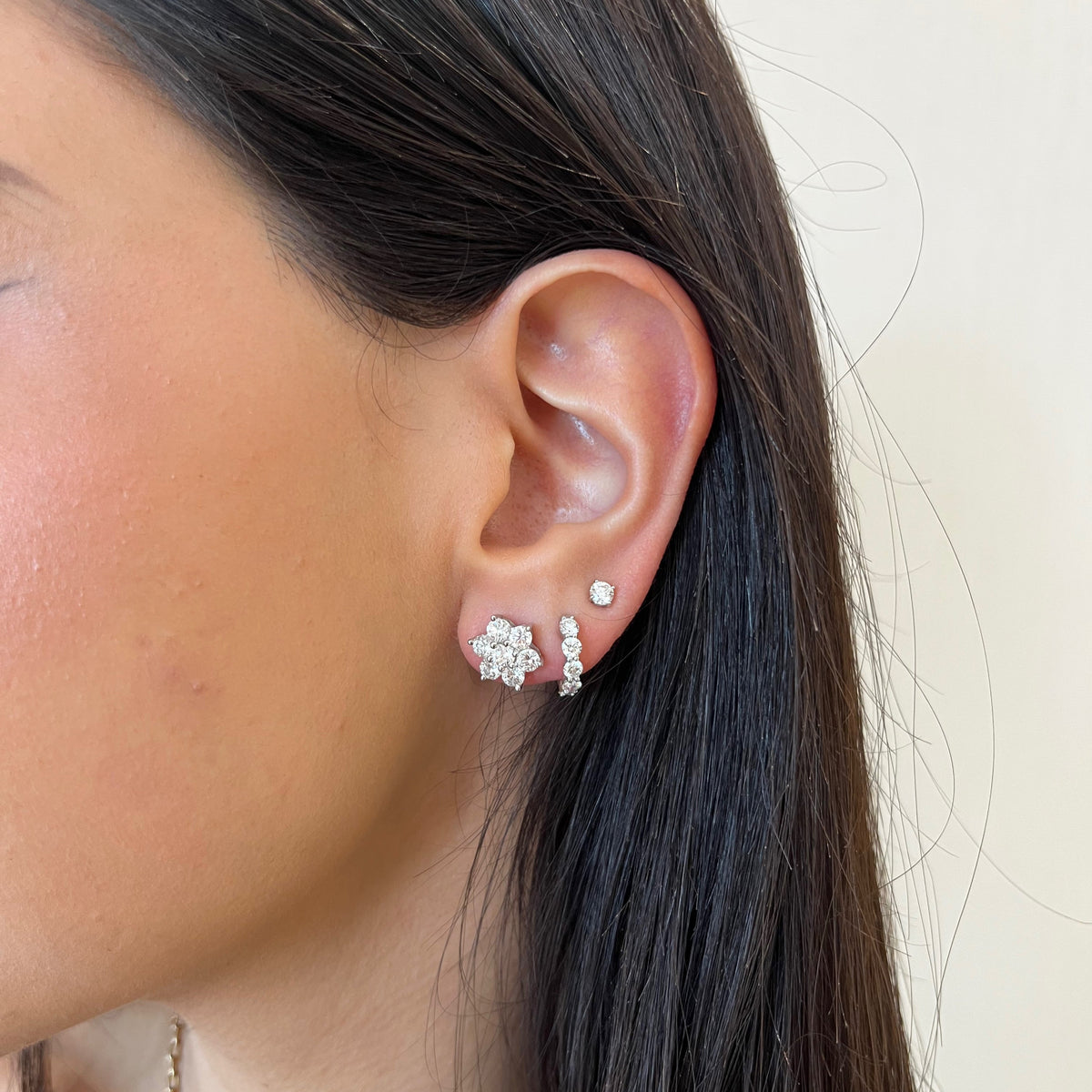 Female Model Wearing Diamond Lily Stud Earrings - 18K gold weighing 2.97 grams - 14 round diamonds weighing 2.17 carats