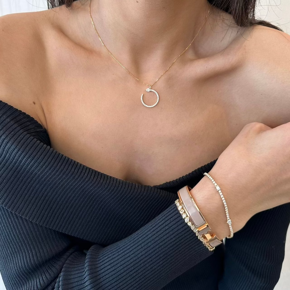 Female model wearing Diamond tennis bracelet with mixed shapes - 14K gold weighing 8.70 grams
- 74 round diamonds weighing 1.58 carats
- 5 mixed shape diamonds weighing 1.08 carats 