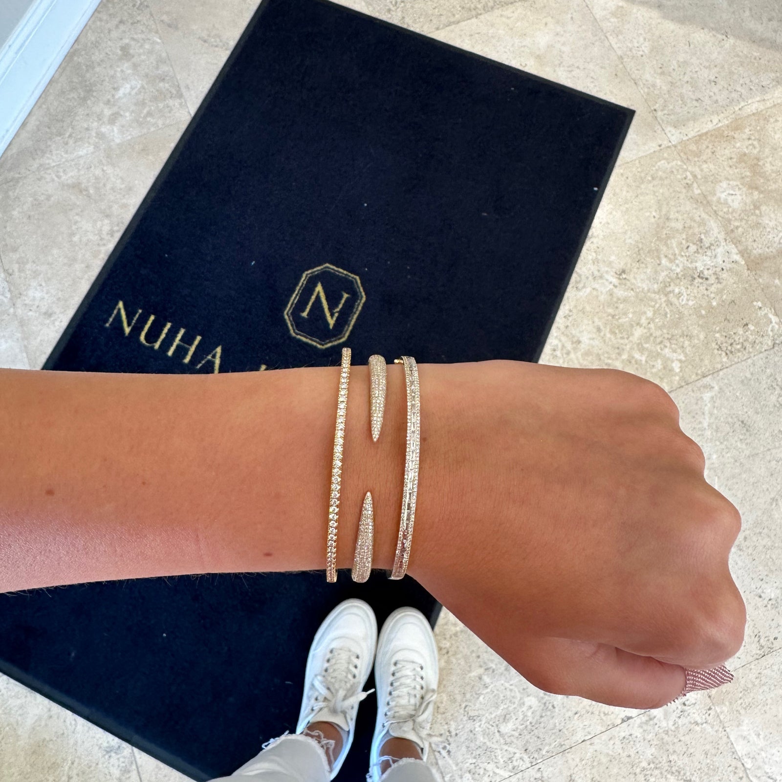 Diamond Eternity Bangle Bracelet  -14K gold weighing 10 grams  -94 shared prong-set round diamonds totaling 1.50 carats