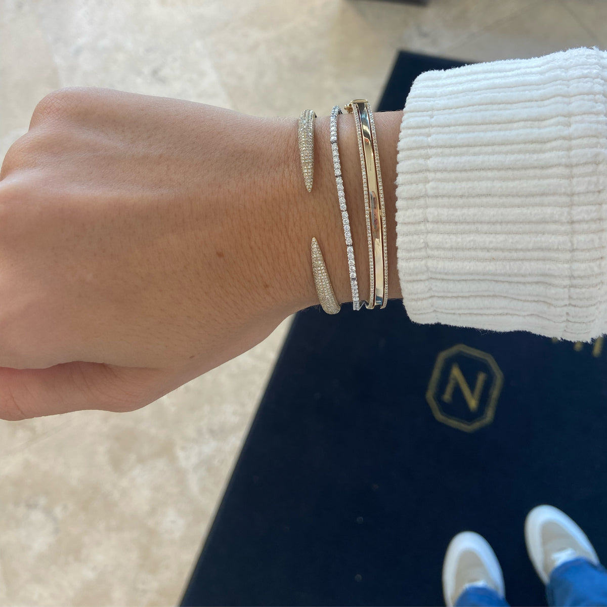 Female model wearing Pave diamond claw cuff bracelet - 14K gold weighing 11.18 grams
- 396 round diamonds weighing 0.94 carats