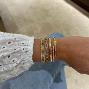 Female Model Wearing Solid 18K yellow gold weighing 17.26 grams with 10 round diamonds weighing 0.40 carats Diamond Dot Bangle | Nuha Jewelers