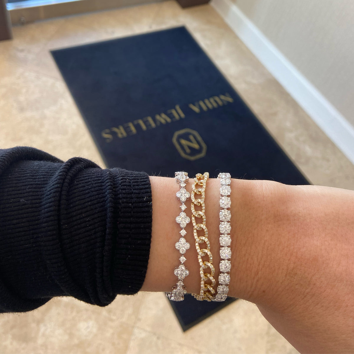Female Model Wearing Diamond Clover Link Bracelet - 18K gold weighing 12.20 grams - 102 round diamonds weighing 4.68 carats