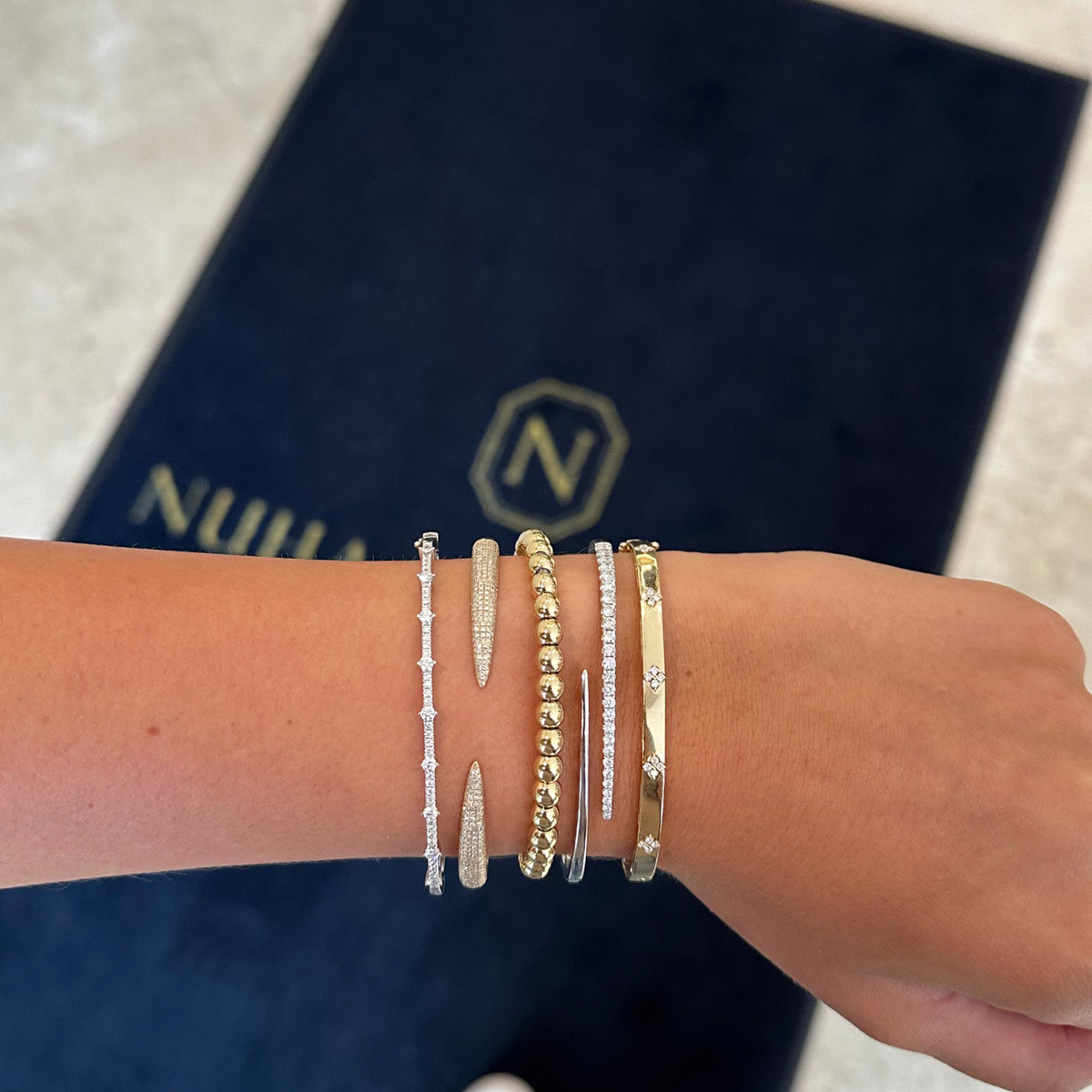 Female model wearing Pave diamond claw cuff bracelet - 14K gold weighing 11.18 grams
- 396 round diamonds weighing 0.94 carats