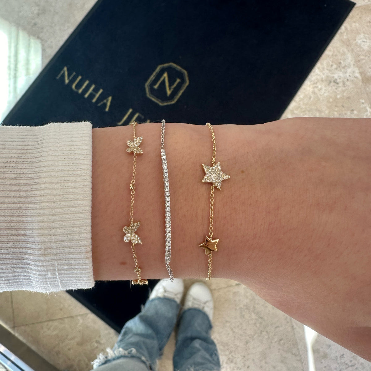 Female Model Wearing Diamond Butterflies Cable Chain Bracelet - 14K gold weighing 2.02 grams - 136 round diamonds weighing 0.42 carats