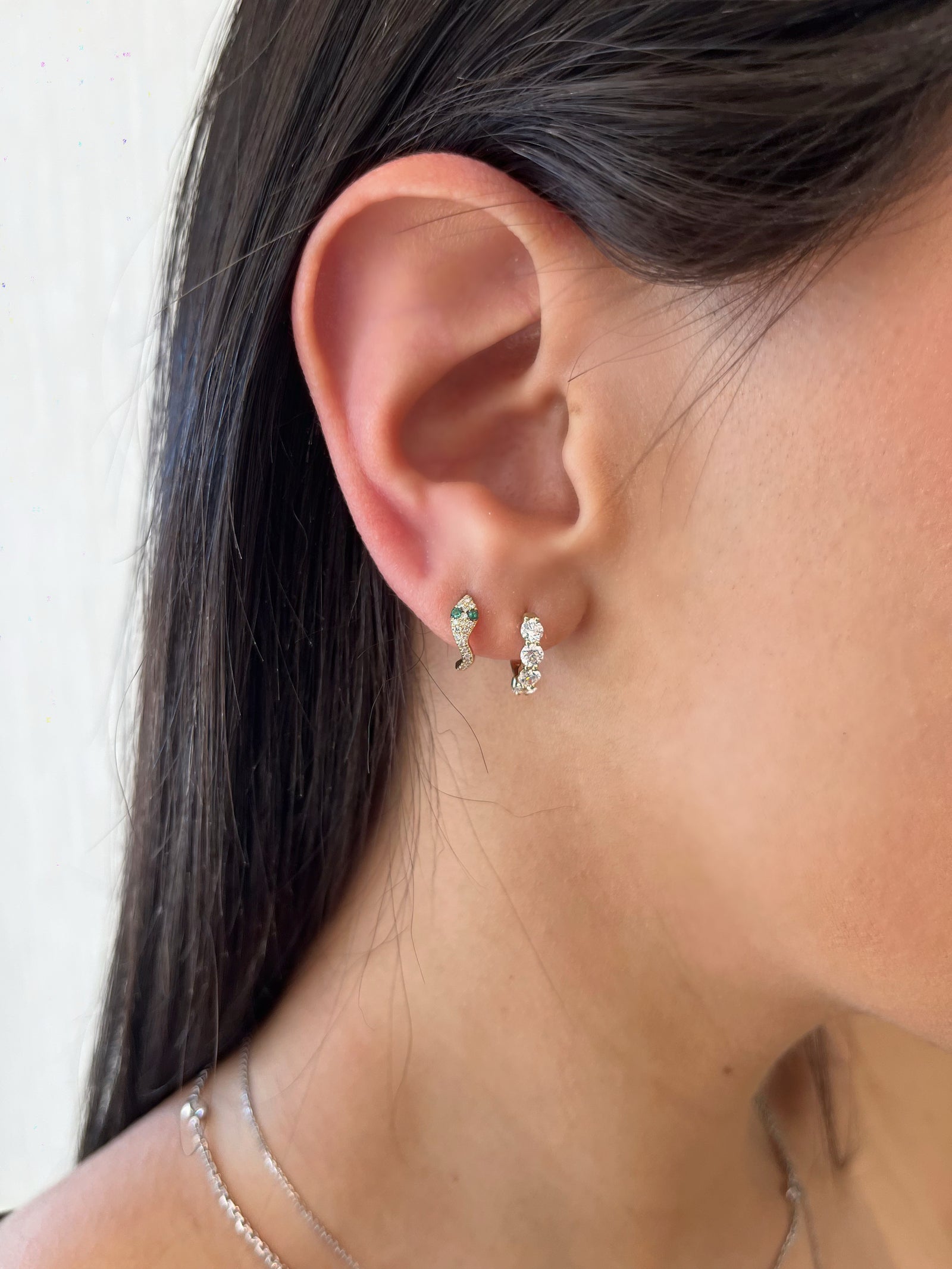 Emerald & Diamond Snake Huggie Earrings - 14K gold weighing 1.46 grams  - 42 round diamonds weighing 0.13 carats  - 4 emeralds weighing 0.40 carats